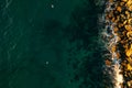 Birds eye aerial view of some seagulls standing on a beach and flying over the sea Royalty Free Stock Photo