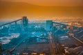 Birds-eye view at coal mining process with machinery at dawn Royalty Free Stock Photo