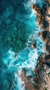 A birds eye view of ocean waves crashing against rocky cliffs along the coast Royalty Free Stock Photo