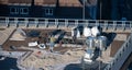 Birds eye view of a roof construction site. Professional placing of gravel stones on a flat roof builing Royalty Free Stock Photo