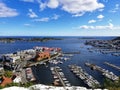 Birds eye view shot of houses, building and multicolored boats in the water in Risor, Norway Royalty Free Stock Photo