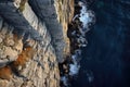 birds-eye view of a steep rock cliff overlooking a ocean water shore. Cabo Girao Royalty Free Stock Photo