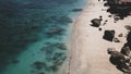 Birds eye view of transparent blue waters with coral reefs, cliffs rocks on tropical island. Top view aerial photo from flying dro