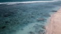 Birds eye view of transparent blue waters with coral reefs and cliffs on tropical island. Top view aerial photo from flying drone Royalty Free Stock Photo