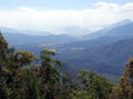 A birds eye view of a valley from the Atherton Tablelands towards Innisfail in Queensland, Australia showing a bush fire in the di