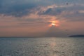 Birds Flock Flying over Lake Leman with Sunrise behind Clouds an Royalty Free Stock Photo