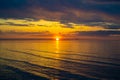 Birds fly low over the water. Seagull on sea. Colorful clouds on sunset Royalty Free Stock Photo