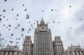 Birds fly over the building of the Russian Ministry of Foreign A Royalty Free Stock Photo