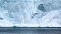 Birds flying behind a turquoise iceberg Antarctica. Antarctic petrels in front of huge icebergs