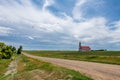 Birds flying over a gravel road near St. MartinÃ¢â¬â¢s Roman Catholic Church in Billimun, Saskatchewa Royalty Free Stock Photo