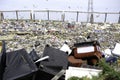 Birds flying over items disposed at a landfill