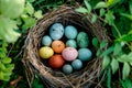 A birds nest with pastel Easter eggs, each uniquely painted with unique pattern on a solid background Royalty Free Stock Photo