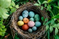 A birds nest with pastel Easter eggs, each uniquely painted with unique pattern on a solid background Royalty Free Stock Photo