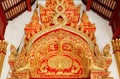 Birds and patterns in old style of royal Thailand at carved decoration over the entrance in traditional Buddhist temple