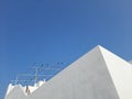 Birds perching on the carcass of a white building against the blue sky Royalty Free Stock Photo