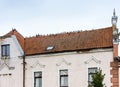 Birds sit exactly in a row on the old house, a flock of pigeons on the roof Royalty Free Stock Photo