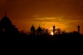 Beautiful sunset against the golden rays of a setting Sun as birds return to their peaceful nests. The Mughal architecture stands