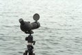 Birdwatching spotting scope monocular on a tripod near the water Royalty Free Stock Photo