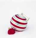 Birght, shiny red and green glass Christmas ornaments baubles decorations on white snow background