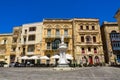 Birgu, Malta Victory square with statue before limestone buildings and balconies in the old city Citta Vittoriosa