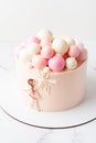 Birhtday cake for a girl with chocolate spheres decoration on top. Little girl holding air balloons Royalty Free Stock Photo