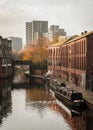 Birmingham gas basin narrowboat with moored canal boats and cityscape modern skyline behind Royalty Free Stock Photo