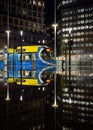 Birmingham Modern city public transport blue metro tram in Centenary Square reflected in water at night