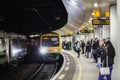 BIRMINGHAM, UK - March 2018 Commuters Waiting for Train Arrival at the Station. Two Coach Car on the Railway Track