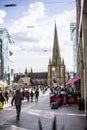 BIRMINGHAM, UK - March 2018 People Walking in the Town Centre West of Birmingham. St. Martins Church and the Cloudy Blue