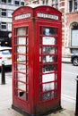 BIRMINGHAM, UK - March 2018 Rusty and Weathered Red Vintage Telephone Booth Standing in the City Street. Common London