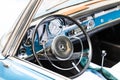 BIRMINGHAM, UK - March 2018 Steel Plated Steering Wheel with Logo Symbol and Dashboard of Vintage Car. Closeup Interior Royalty Free Stock Photo