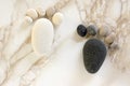 Two tiny stone feet and ten toes on beige background, stone in the shape of a human feet Royalty Free Stock Photo