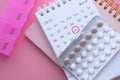 Birth control pill and calendar date with pill box on table Royalty Free Stock Photo