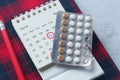 Birth control pills , calendar and notepad on table Royalty Free Stock Photo