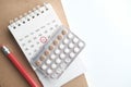 Birth control pills , calendar and notepad on table Royalty Free Stock Photo