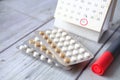 birth control pills , calendar and notepad on table Royalty Free Stock Photo