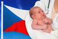 Birth rate in Czech Republic. Newborn baby in hands of doctor