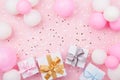 Birthday background with gift or present box, balloons and confetti on pink pastel table top view. Flat lay. Royalty Free Stock Photo