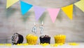 Birthday background with number 47. Beautiful birthday card with colorful garlands, a muffin with a candle burning copyspace. Royalty Free Stock Photo