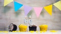 Birthday background with number 60. Beautiful birthday card with colorful garlands, a muffin with a candle burning copyspace. Royalty Free Stock Photo