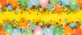 Birthday background top view. Balloons and various party decorations on yellow background