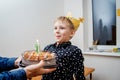 Birthday boy blowing out the candle on the cake Royalty Free Stock Photo