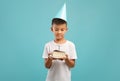 Birthday Boy. Happy Chinese Male Child Holding Piece Of Cake With Candle Royalty Free Stock Photo