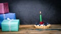 Birthday cake with berries and one lighted candle Royalty Free Stock Photo