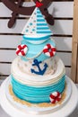 Birthday cake with blue anchor, life belt and sailing boat Royalty Free Stock Photo