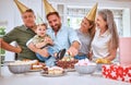 Birthday cake for boy child, home with family and celebrate with food in Texas kitchen. Happy baby smiles in dads arms Royalty Free Stock Photo