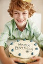 Birthday cake, boy and happy in portrait at table in family home for celebration, growth and memory. Child, dessert and Royalty Free Stock Photo