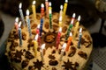 Birthday cake with burning candles in the dark