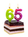 Birthday cake with burning candles for 65th anniversary Royalty Free Stock Photo