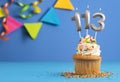 Birthday cake with candle number 113 - Blue background